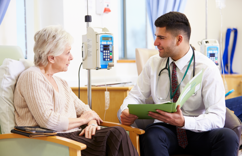 Specialty pharmacist discussing treatment plan with an elderly patient