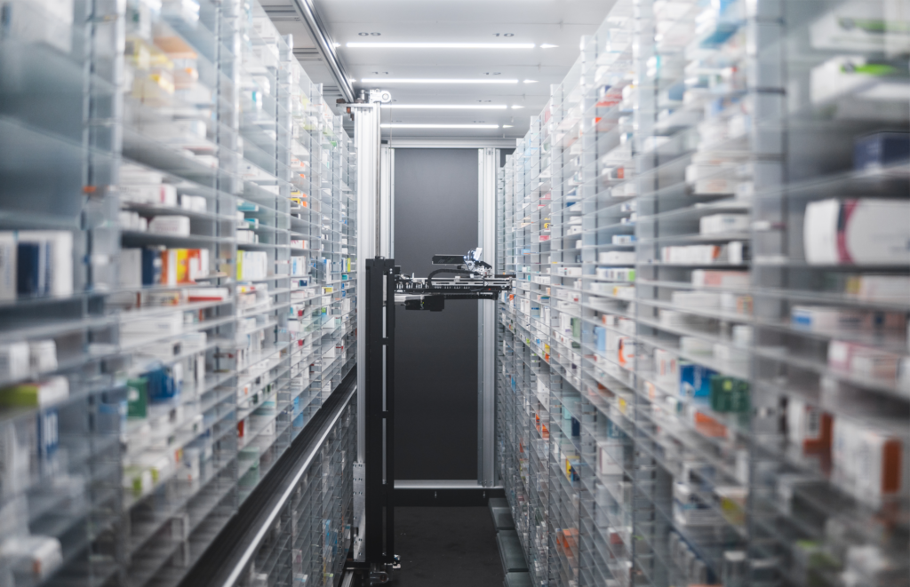 AI in specialty pharmacy robotic AI device selecting medications from the shelf.